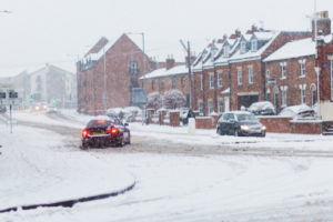cars sliding while driving in a snow storm