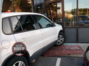car drives into store front